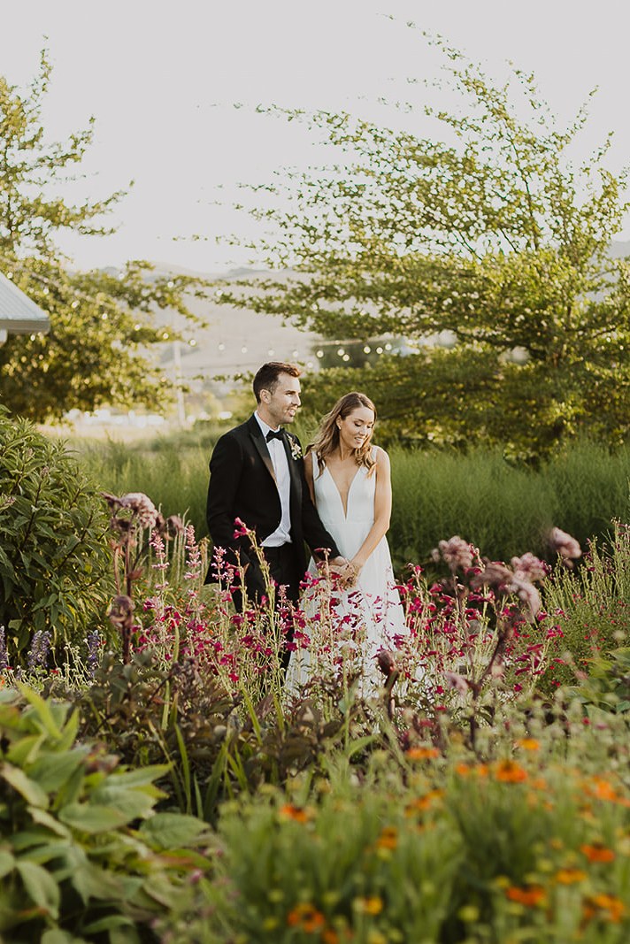 A Bride And Groom Amongst Plants In Cornerstone Gardens