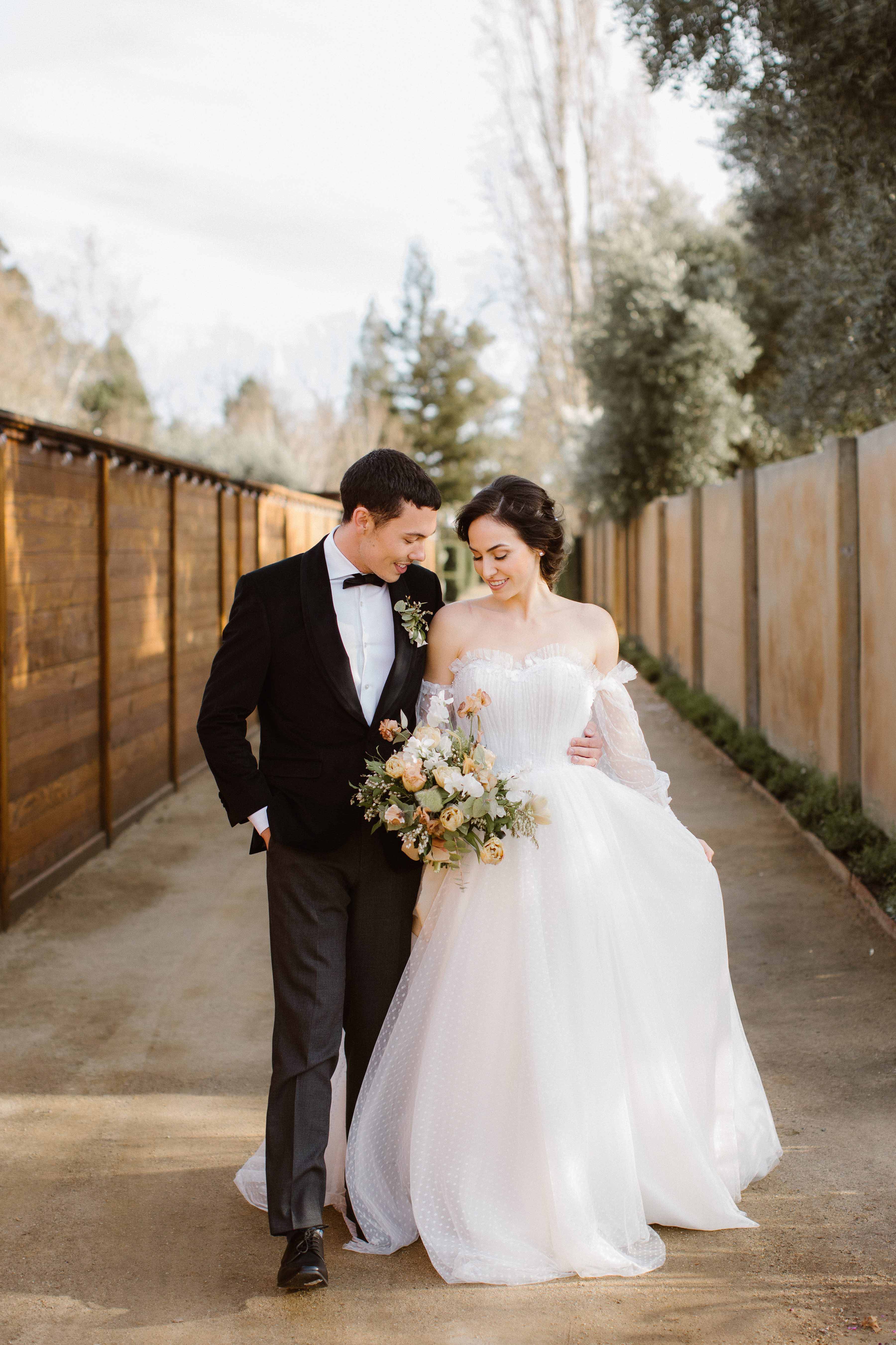 bride and groom walking down pathway