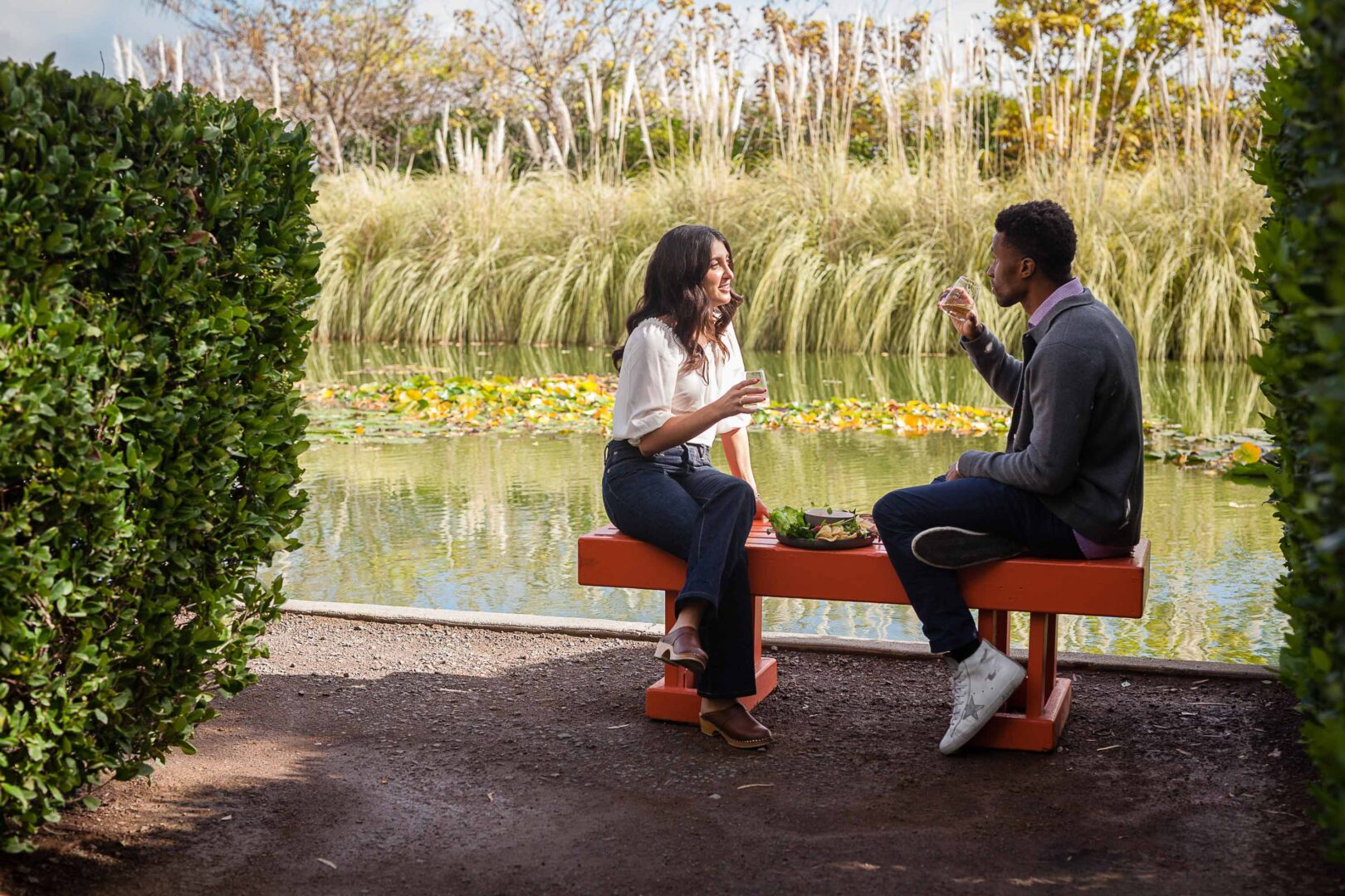 couple eating in the gardens by pond